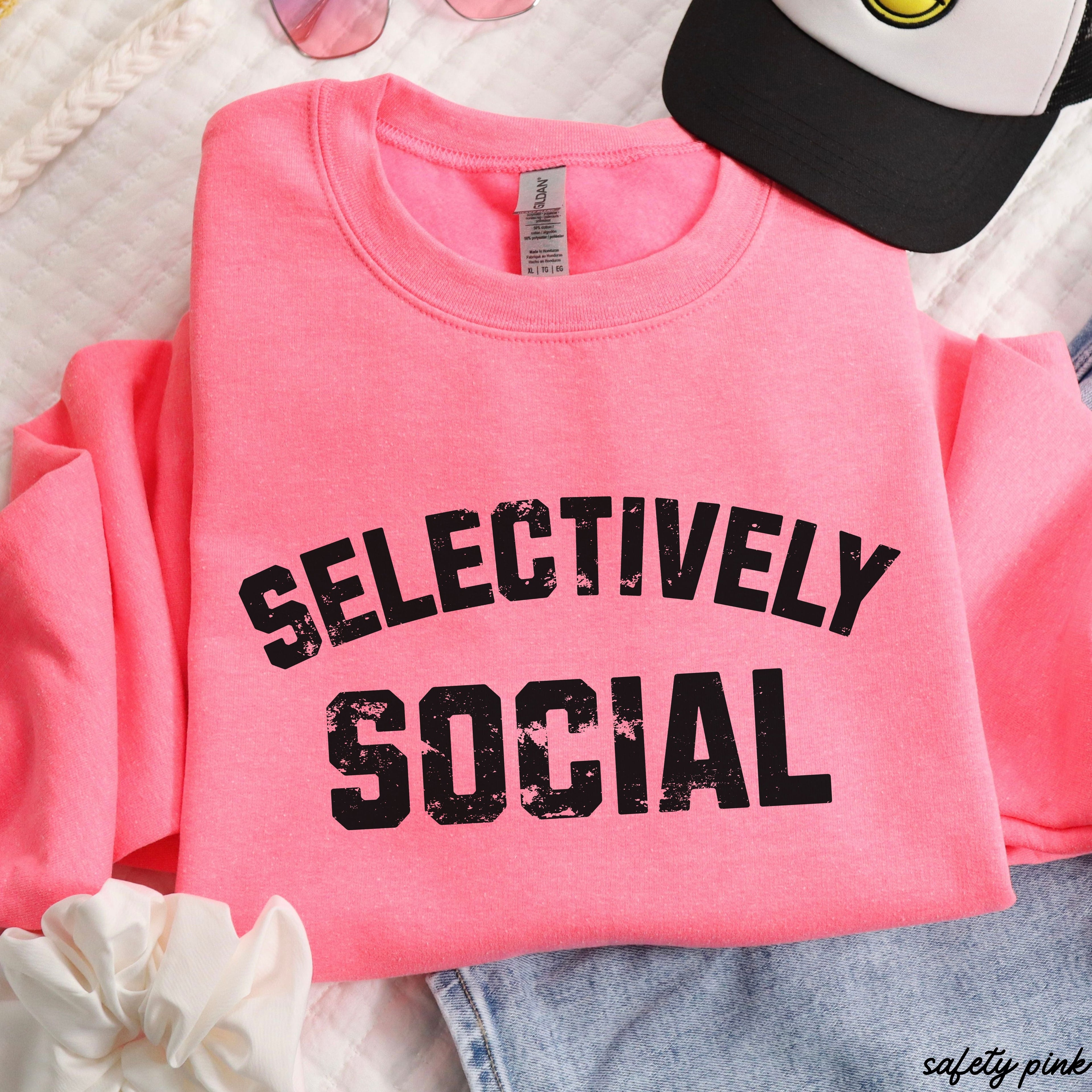 PRE-ORDER Selectively Social Sweatshirt 7 Colors S-3X in safety pink color on a flat lay with accessories.