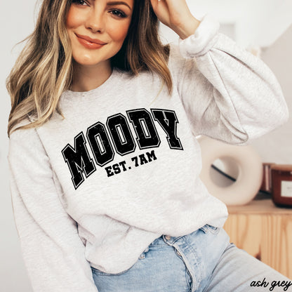 Woman wearing a Moody 7am Sweatshirt 7 Colors S-3X in ash grey, showcasing its comfy fit and stylish design.